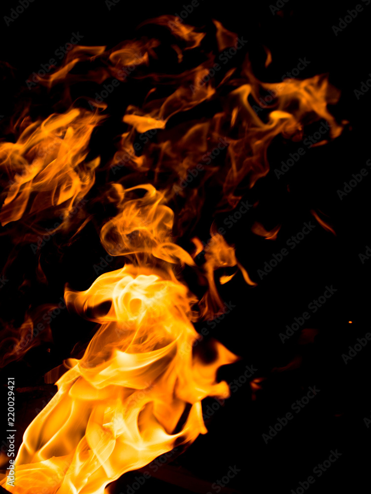 Flame of fire with sparks on a black background