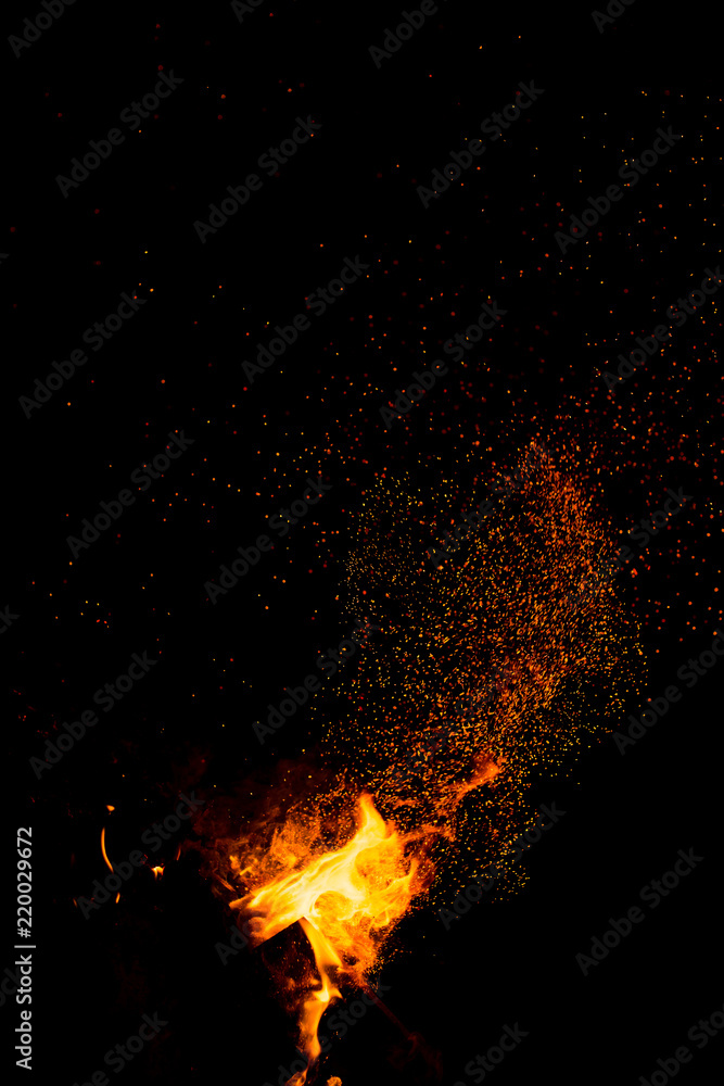 Flame of fire with sparks on a black background