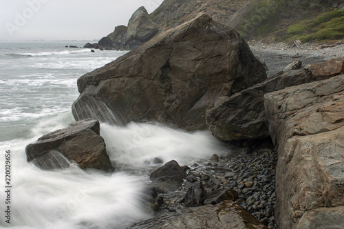 Waves crash along the rocky shoreline on Steep Ravine Beach in Mount Tamalpais, CA