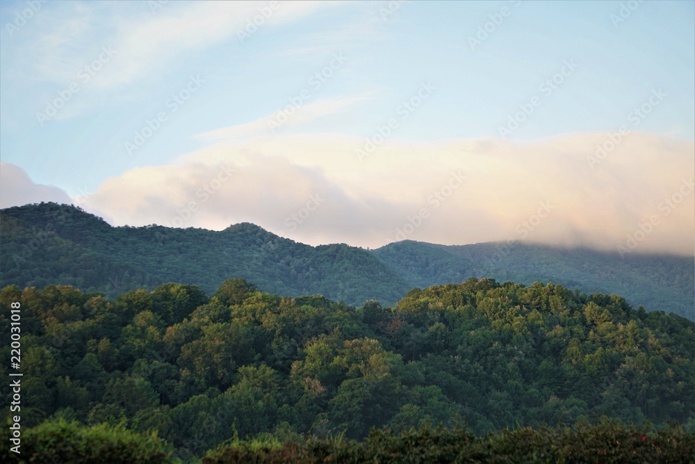 Beautiful high mountain with blue sky and white cumulus clouds on a sunny day in the summertime, NC USA.