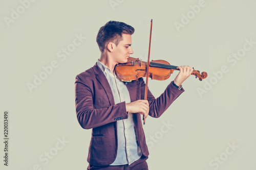 Young man playing on wooden violin