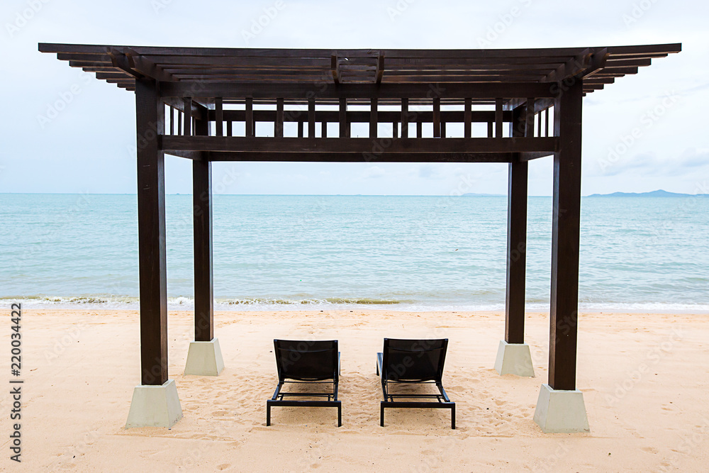 Two relaxing chairs on the sea beach. sunbathe relax. rest in the holiday. natural scenery holiday. tourism promotion concept. summer season. private honeymoon sweet trip concept. Two relaxing chairs on the sea beach. sunbathe relax. rest in the holiday. natural scenery holiday. tourism promotion concept. summer season. private honeymoon sweet trip concept.