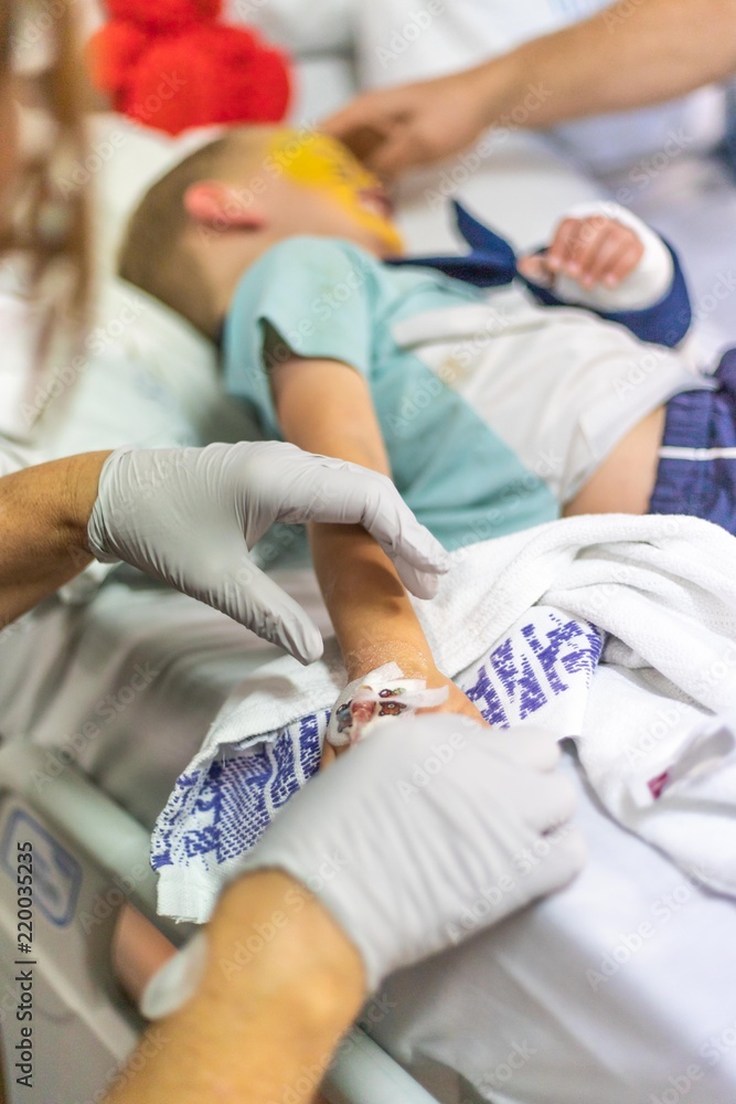 Young Boy in Hospital with Broken Arm Getting Cannula Removed