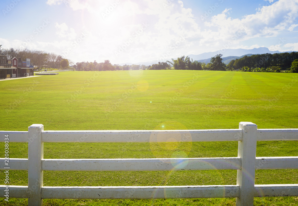 landscape of farm view behind white fence and light fair landscape of farm view behind white fence and light fair