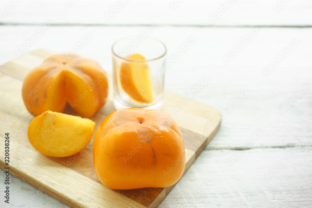 Persimmon on a white background, persimmon orange in front view
