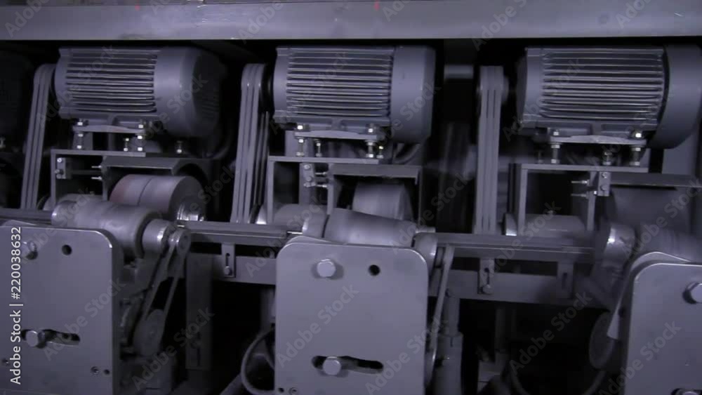 Grinding machine processes stainless steel pipes in factory. Welded profile pipes are made of alloy steel. Rolled metal product manufacturing. Grinding machine processes stainless steel pipes in factory. Welded profile pipes are made of alloy steel. Rolled metal product manufacturing.