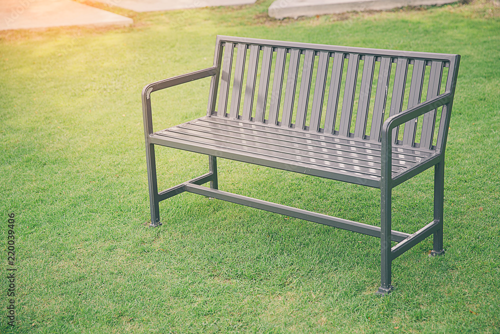 Stylish bench in summer park. public chair in the garden at morning and tree in nature background,Public chair in the park . Blank old bench in the public park. Stylish bench in summer park. public chair in the garden at morning and tree in nature background,Public chair in the park . Blank old bench in the public park.