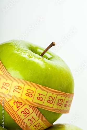 Green Apple Wrapped With Tape Measure Close-up