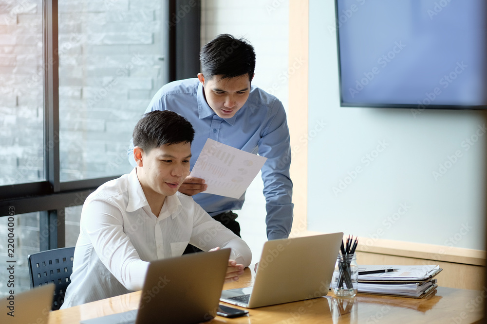 Business partner working with laptop, Two colleagues discussion with business consult. Business partner working with laptop, Two colleagues discussion with business consult.