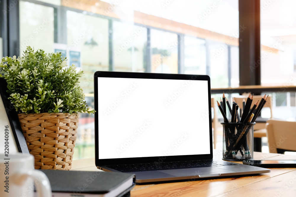 Fototapeta premium Mockup laptop computer on wooden table in office workspace.