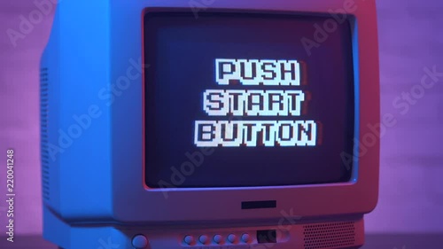 Push start button flashing on a retro video game TV from the 80s or 90s. Vintage CRT screen in a 1980 1990 visual style.