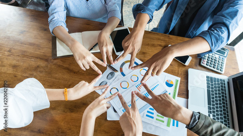 People in team harmonious hand meeting with worm light