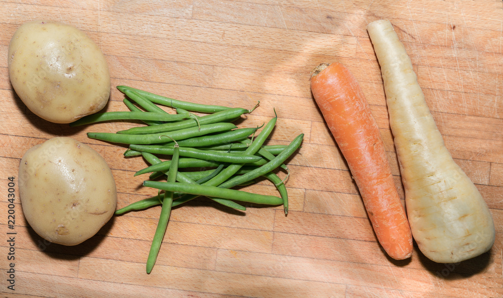 Four basic vegetable on old wooden board Four basic vegetable on old wooden board