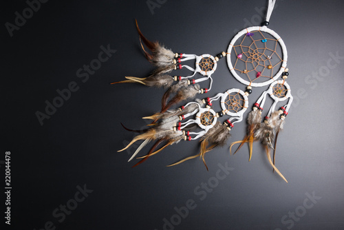 Valokuva Dream catcher with feathers threads and beads rope hanging spiritual folk american native indian amulet isolated on black background
