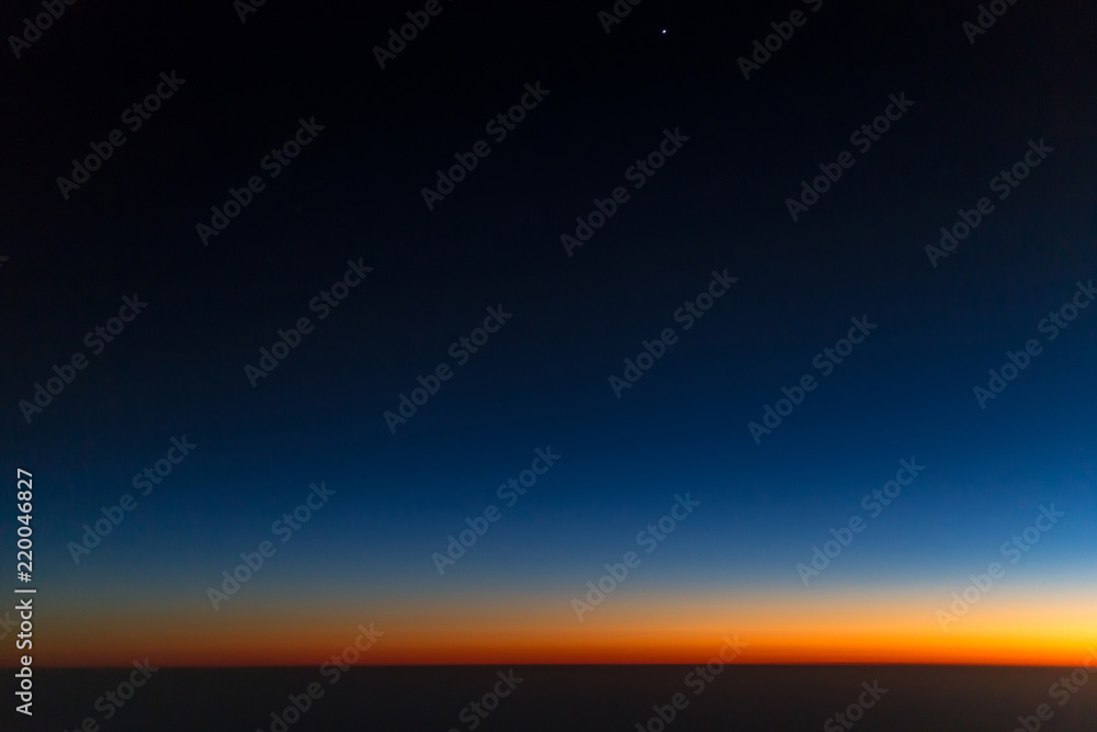 Airplane window view on sunset