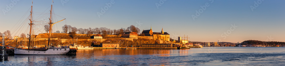 Panorama of Oslo city skyline and harbor in front of Akershus Fortress during sunset in Norway