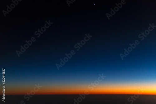 Airplane window view on sunset