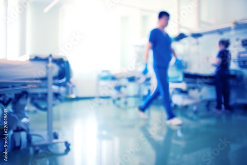 Working medical staff in the bright intensive care unit, unfocused background