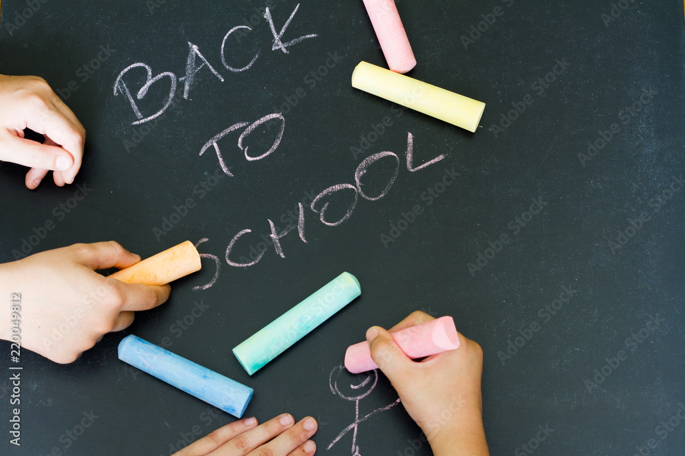 Back to school letters and drawing kids on blackboard Back to school letters and drawing kids on blackboard
