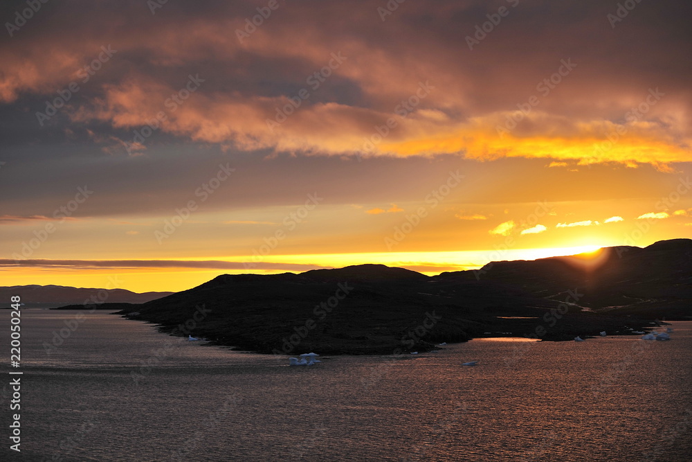 A colorful sunset near the coast of eastern Greenland. A colorful sunset near the coast of eastern Greenland.