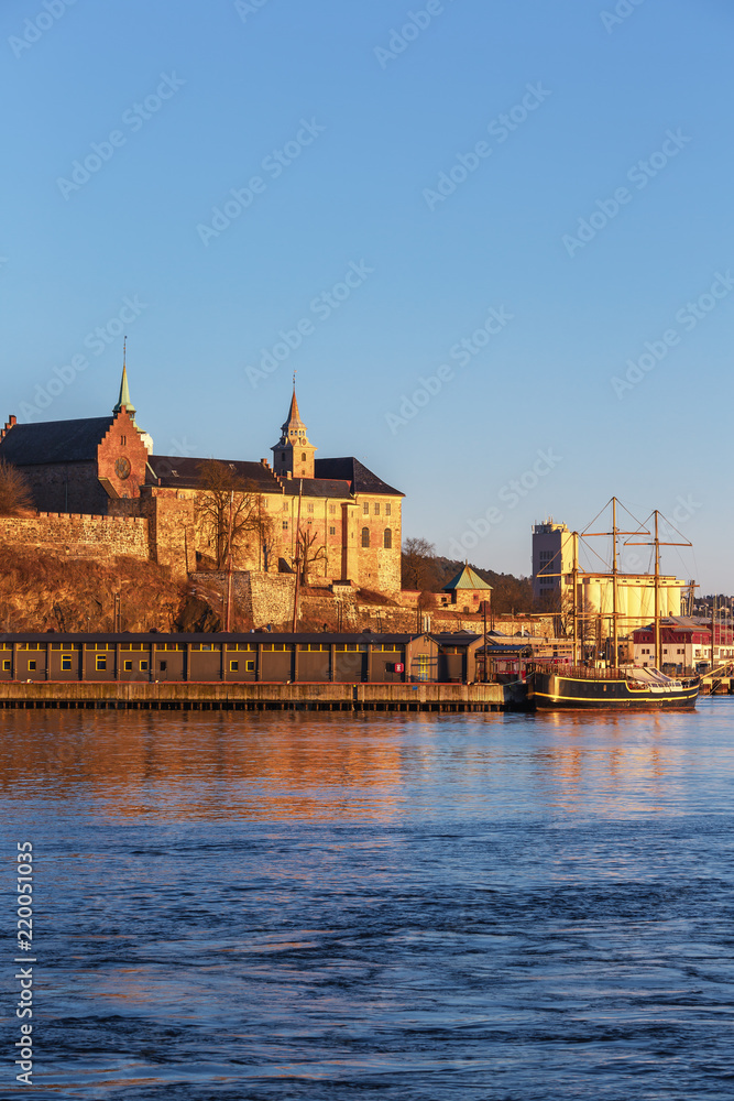 Fototapeta premium Oslo city skyline and harbor in front of Akershus Fortress during sunset in Norway