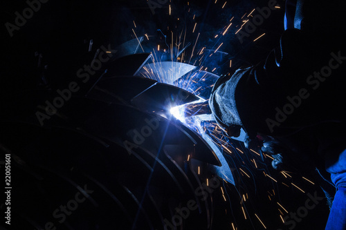 Industrial Worker at the factory welding closeup shot