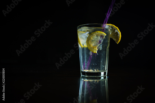 Fresh cocktail on a black background. Alcoholic cocktail on a black background. Fruit with a cocktail. Non-alcoholic cocktail. Mix of cocktails on a black background. 