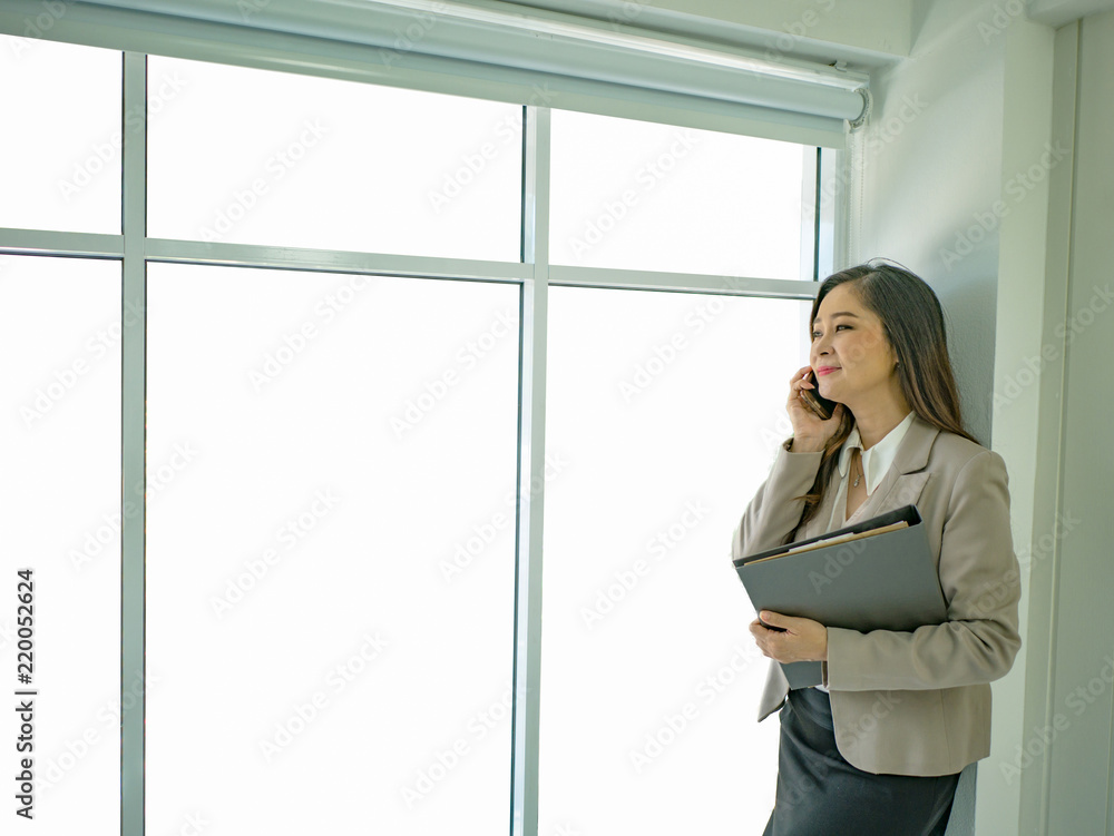 Modern business women talk to mobilephone with white background Modern business women talk to mobilephone with white background