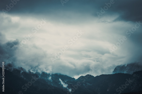 Panoramic view of the European Alps  dark  cloudy background concept