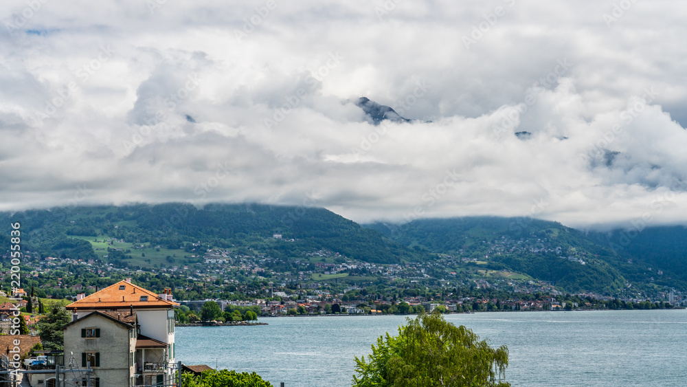 Fototapeta premium Switzerland, scenic view on Alps with fog, clouds near lake Leman