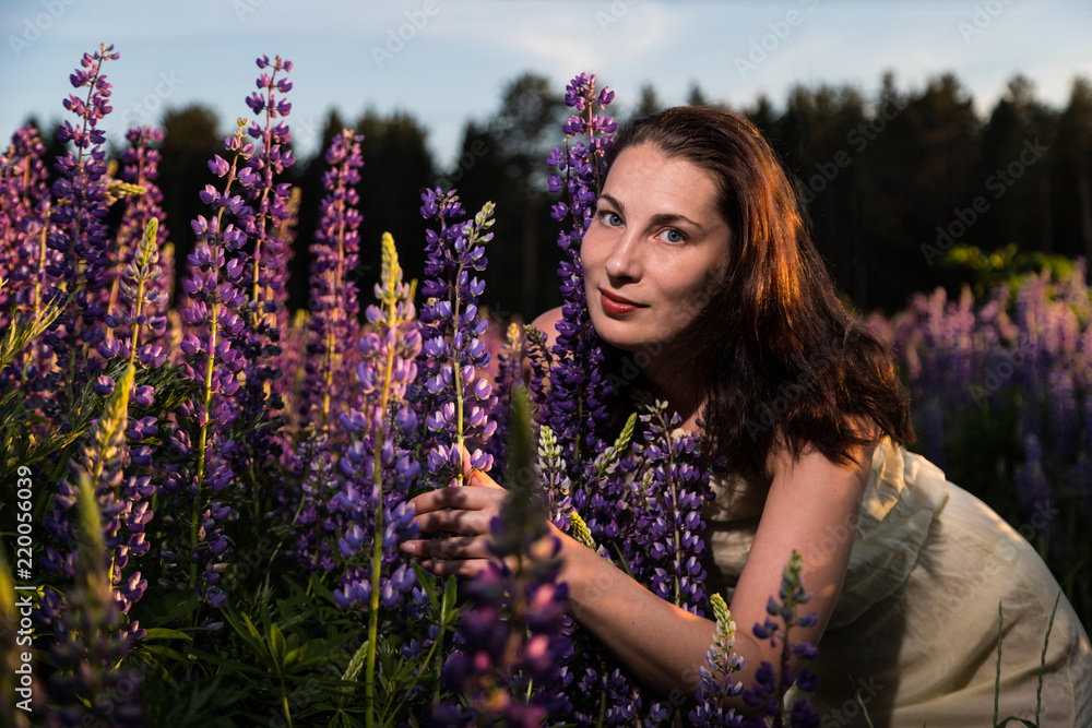 Nice woman in a field of purple lupines Nice woman in a field of purple lupines