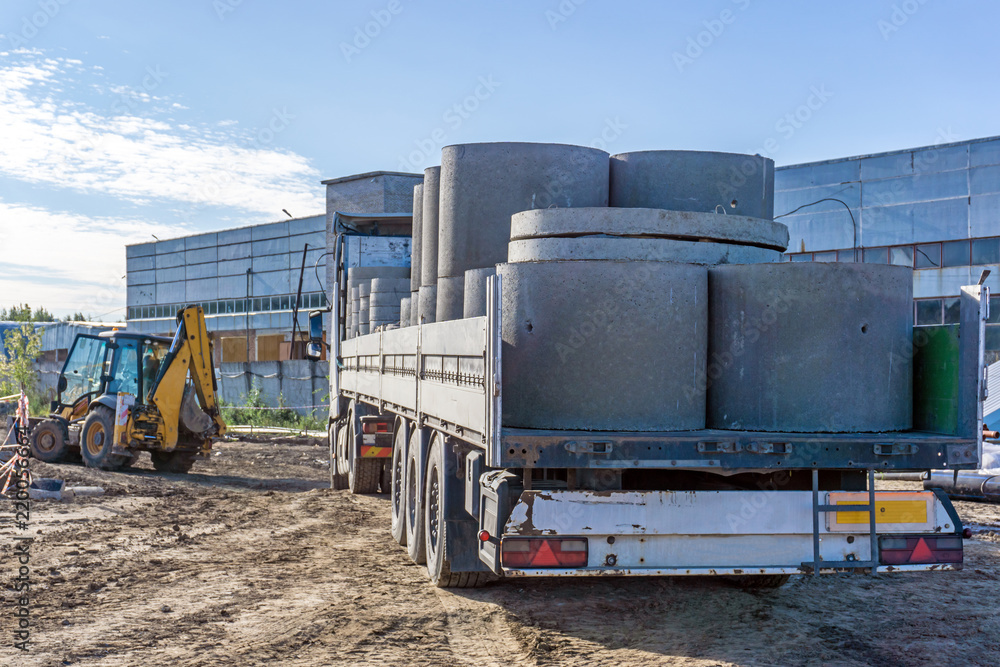 Delivery of building materials for construction site. Concrete rings and elements for a well.