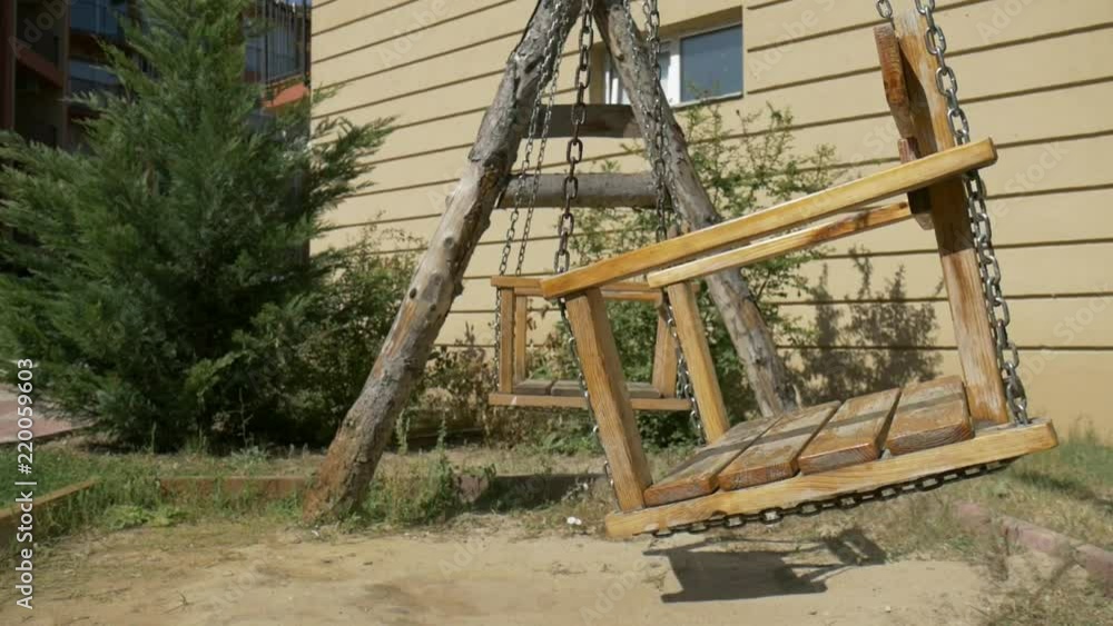 Wooden swing cradle in garden slow-motion Wooden swing cradle in garden slow-motion