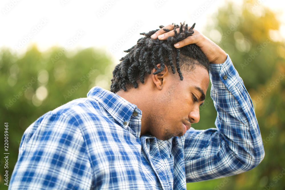 Young African American man in deep thought. Young African American man in deep thought.