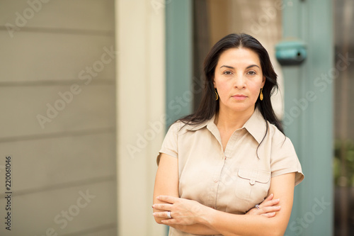 Happy Hispnaic woman smiling and standing outside. Free Download Happy Hispnaic woman smiling and standing outside. - GFXLoad