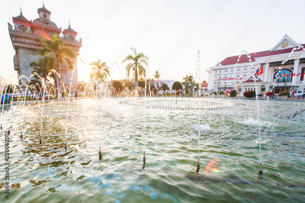 Patuxai or Victory Gate and fountain at sunset.