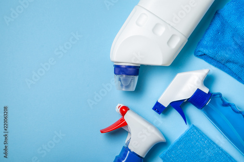 Cleaning supplies - bottles  sprays sponge on bright pastel background