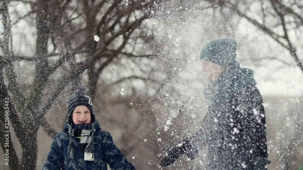 HD Mother and child throw the snow up HD Mother and child throw the snow up
