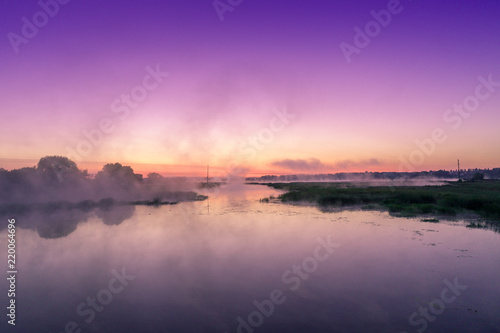 Magical purple sunrise over the river. Misty morning  rural landscape  countryside