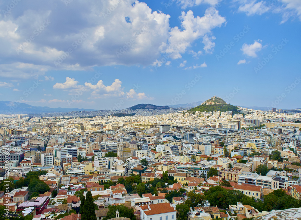 Panoramic view of the city of Athens with the Lykavittos hill in background. View from the viewpoint of Athenian Acropolis. Attica region, Greece.