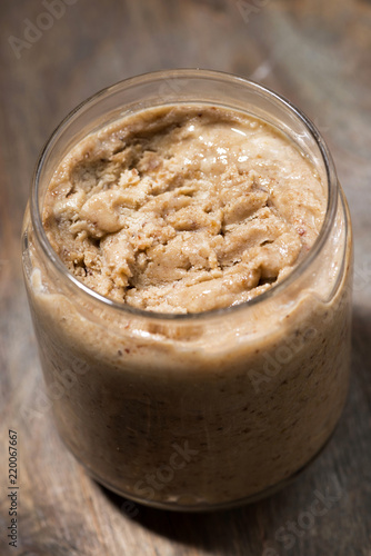 homemade peanut butter in a jar, vertical