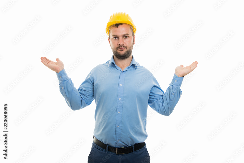 Young architect with yellow helmet showing don't know gesture Young architect with yellow helmet showing don't know gesture