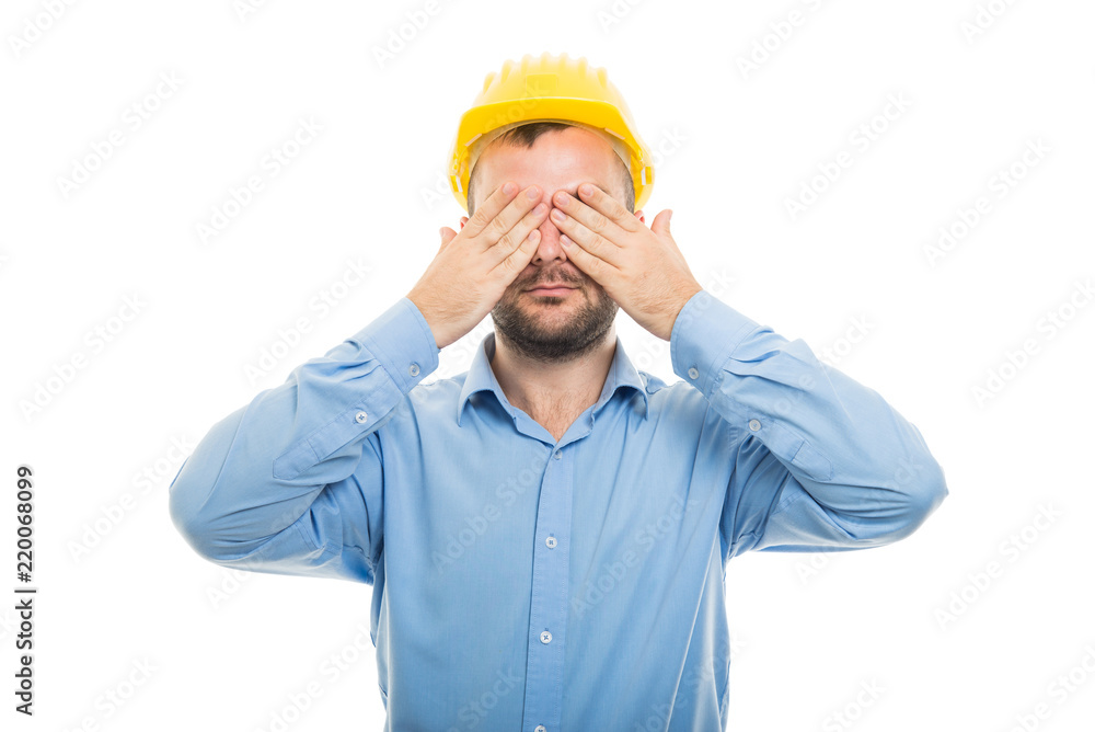 Young architect with yellow helmet covering eyes Young architect with yellow helmet covering eyes