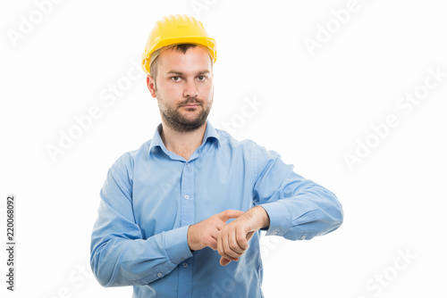 Young architect with yellow helmet showing late gesture © Catalin Pop