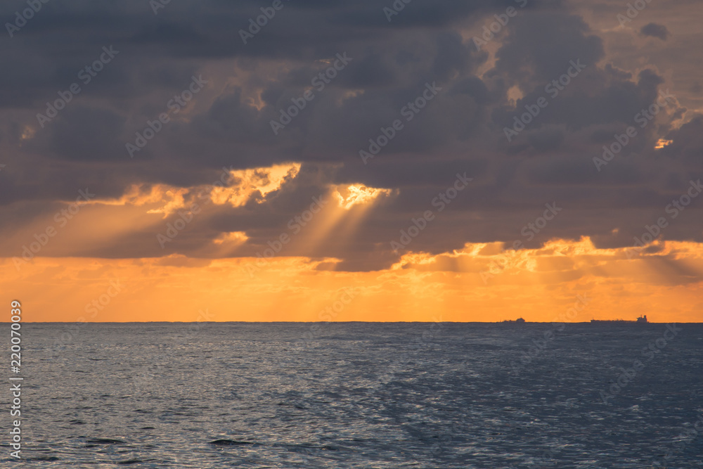 Sunrise over Mediterranean sea - early morning when sun is hidden behind the clouds