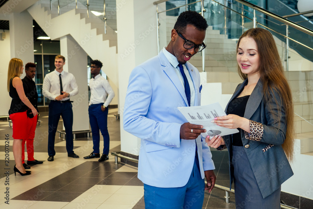 Obraz premium Portrait of ambitious business team diverse ethnicity multinational people in stylish suit getting communicating together in lobby of modern the office .