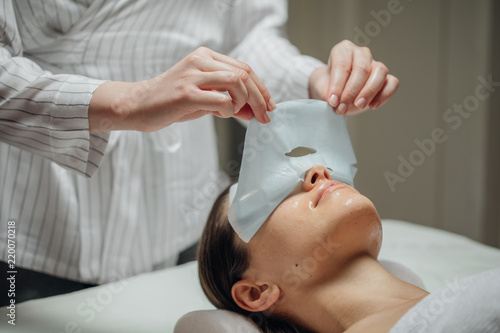 Cosmeotologist Putting a Facial Mask