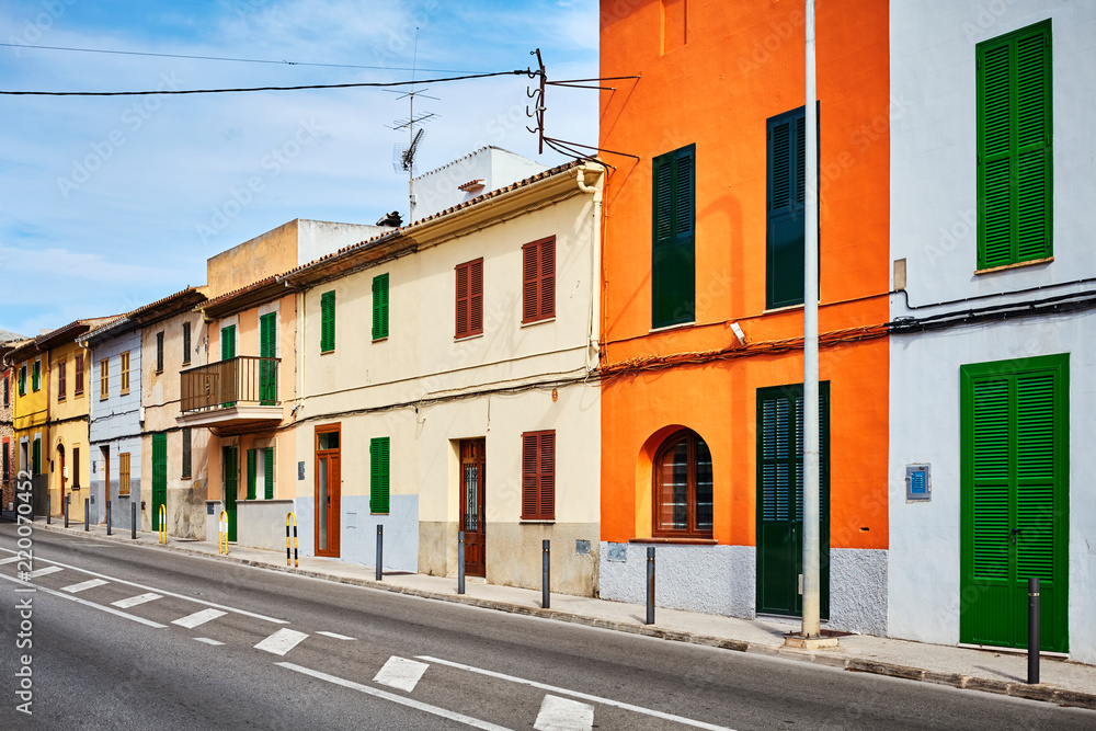 Street in Alcudia with colorful building facades, Mallorca, Spain.