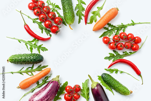 Circle made of different herbs and vegetables isolated on white background. Copy space. Healthy eating background. Food photography. Top view