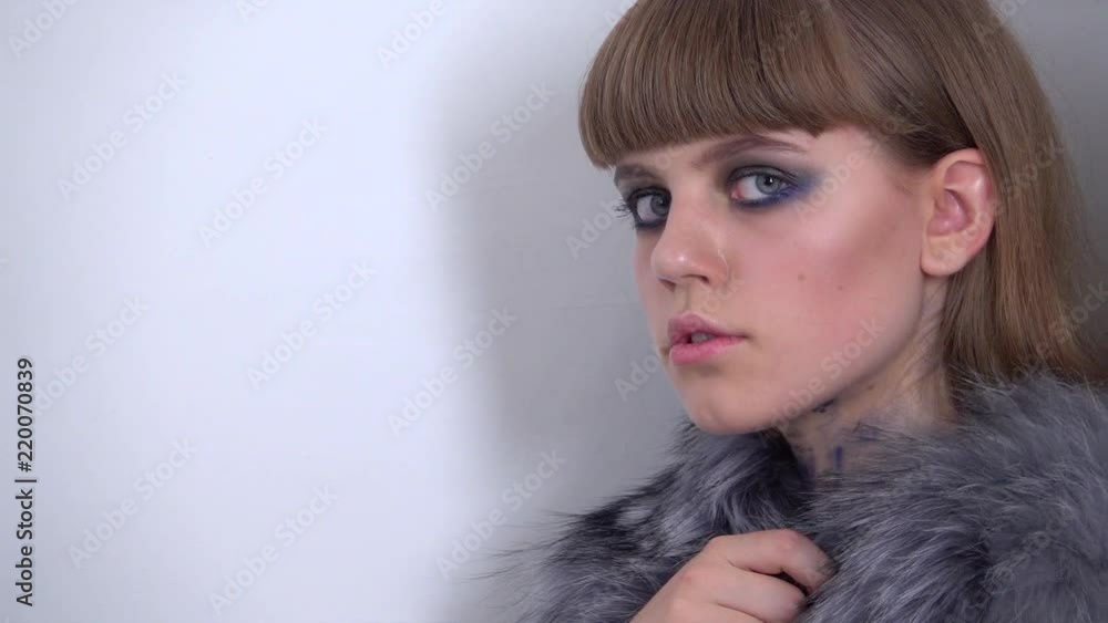 Girl with beautiful make-up looks at the camera. Close up . Slow motion Girl with beautiful make-up looks at the camera. Close up . Slow motion